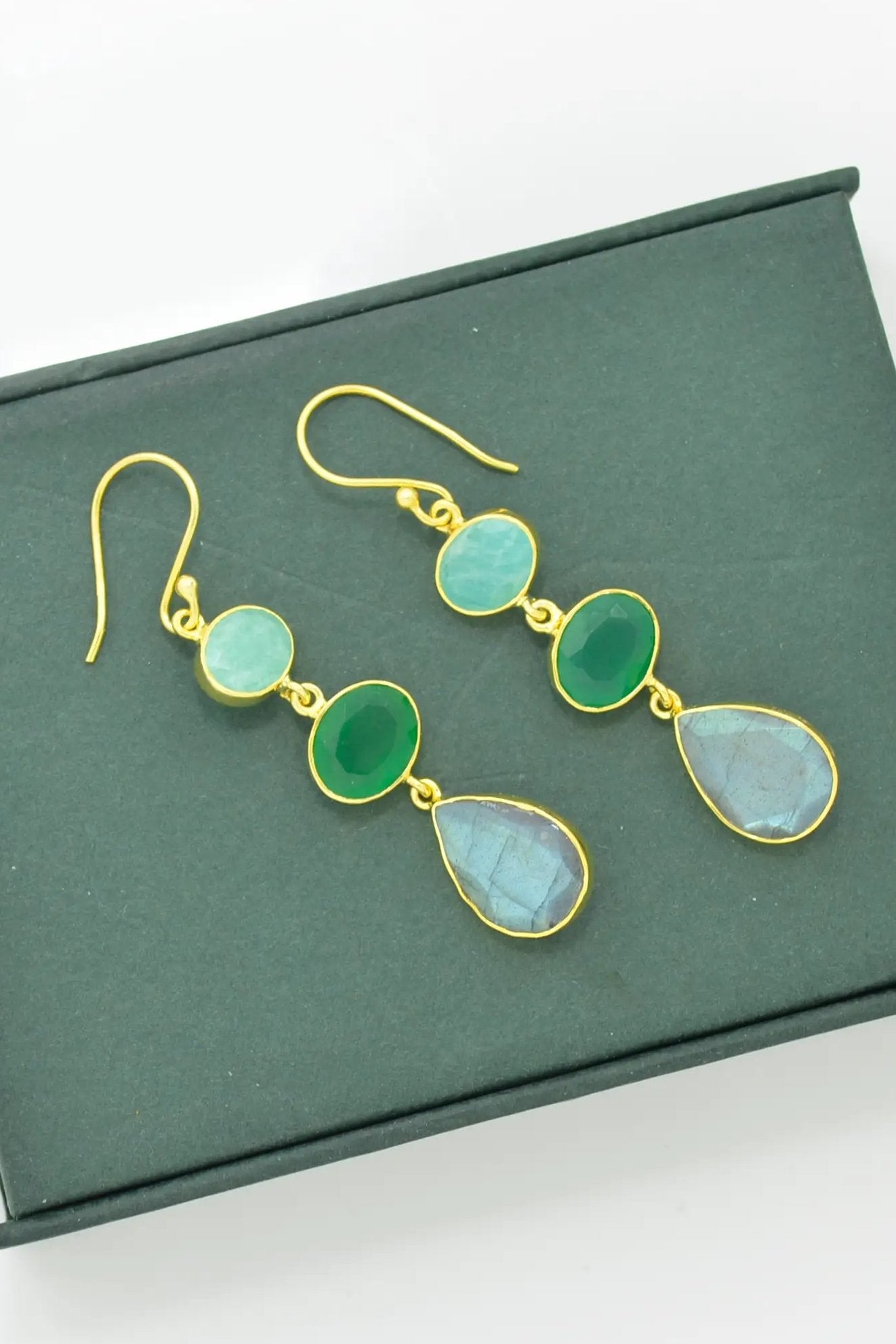 Amazonite, Green Onyx & Labradorite Earrings on a forest green background highlighting the blue green hues