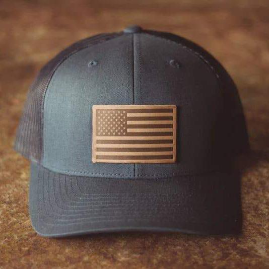 The front of the American Flag Horween Hat laying on a wooden table - L'Atelier Global