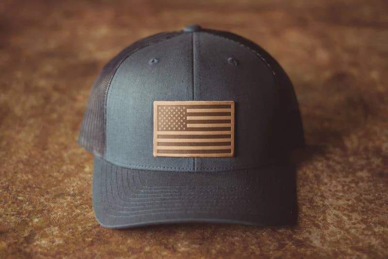 The front of the American Flag Horween Hat laying on a wooden table - L'Atelier Global