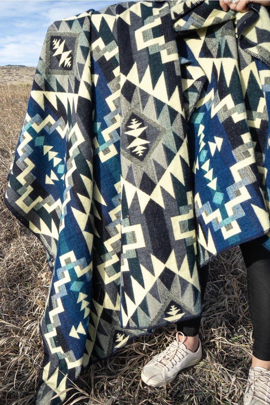 Andean Blue Chakana Alpaca Wool Blanket held by a woman - L'Atelier Global