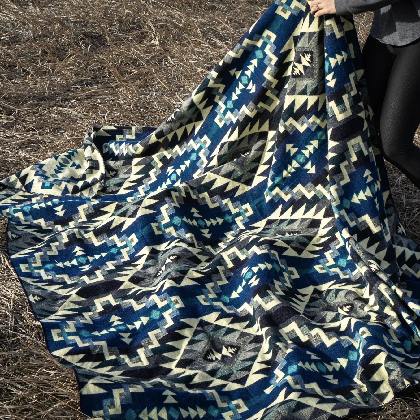 Andean Blue Chakana Alpaca Wool Blanket laying on hay - L'Atelier Global