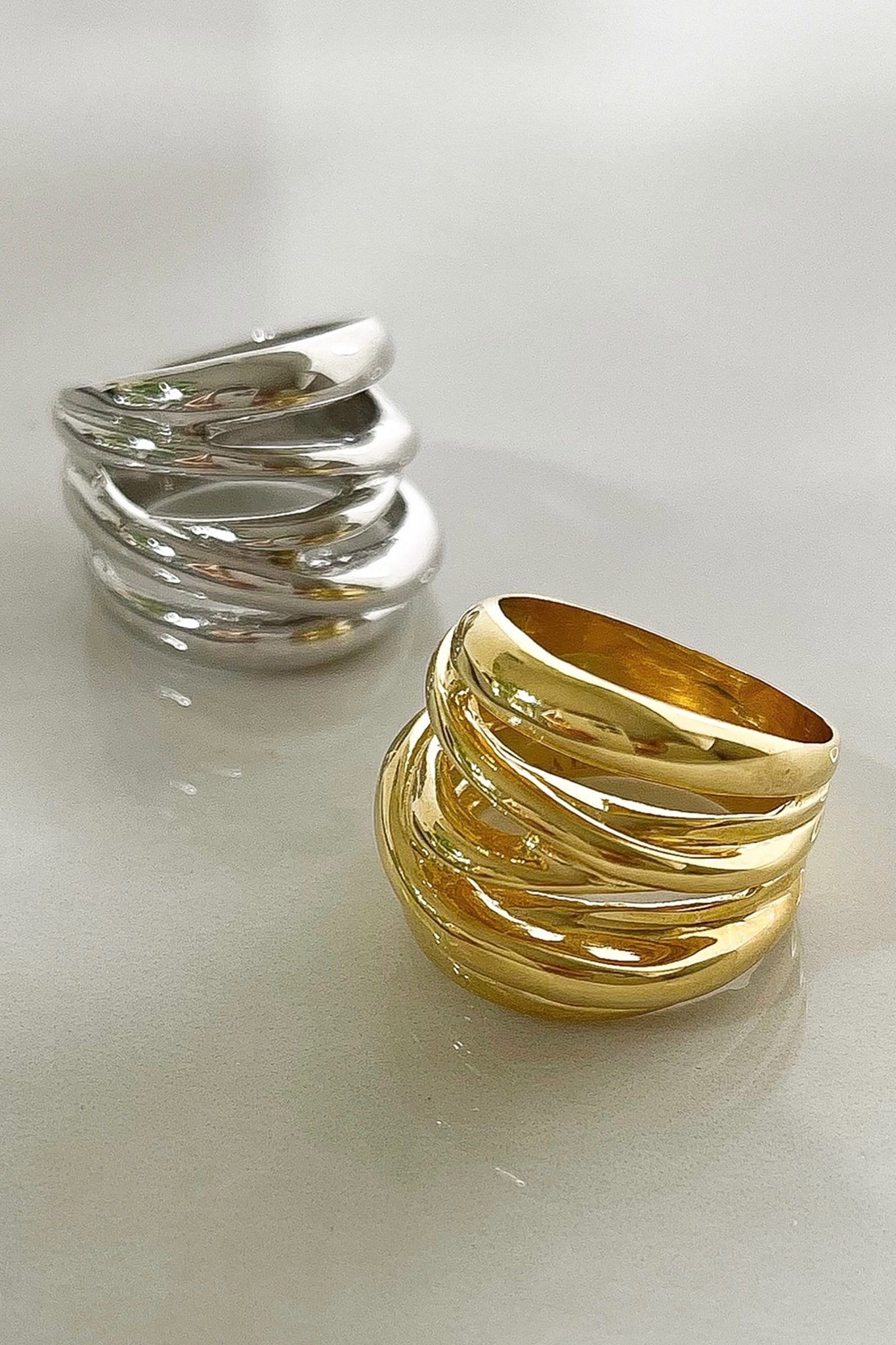 Arezzo Serenity Ring in gold and silver on a light gray background- L'Atelier Global