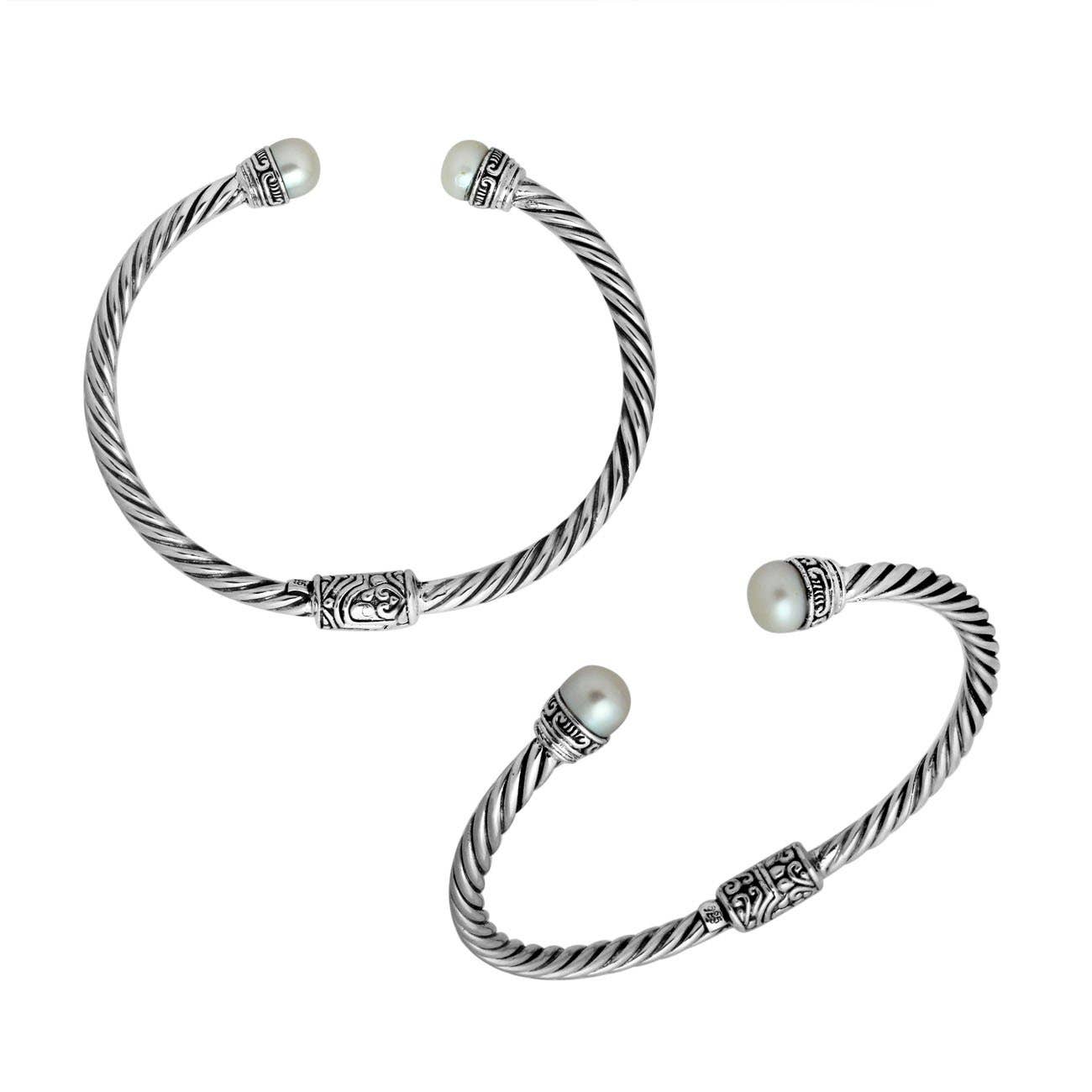 Two Balinese Pearl Hinged Bracelet with pearls on each end on a white background.