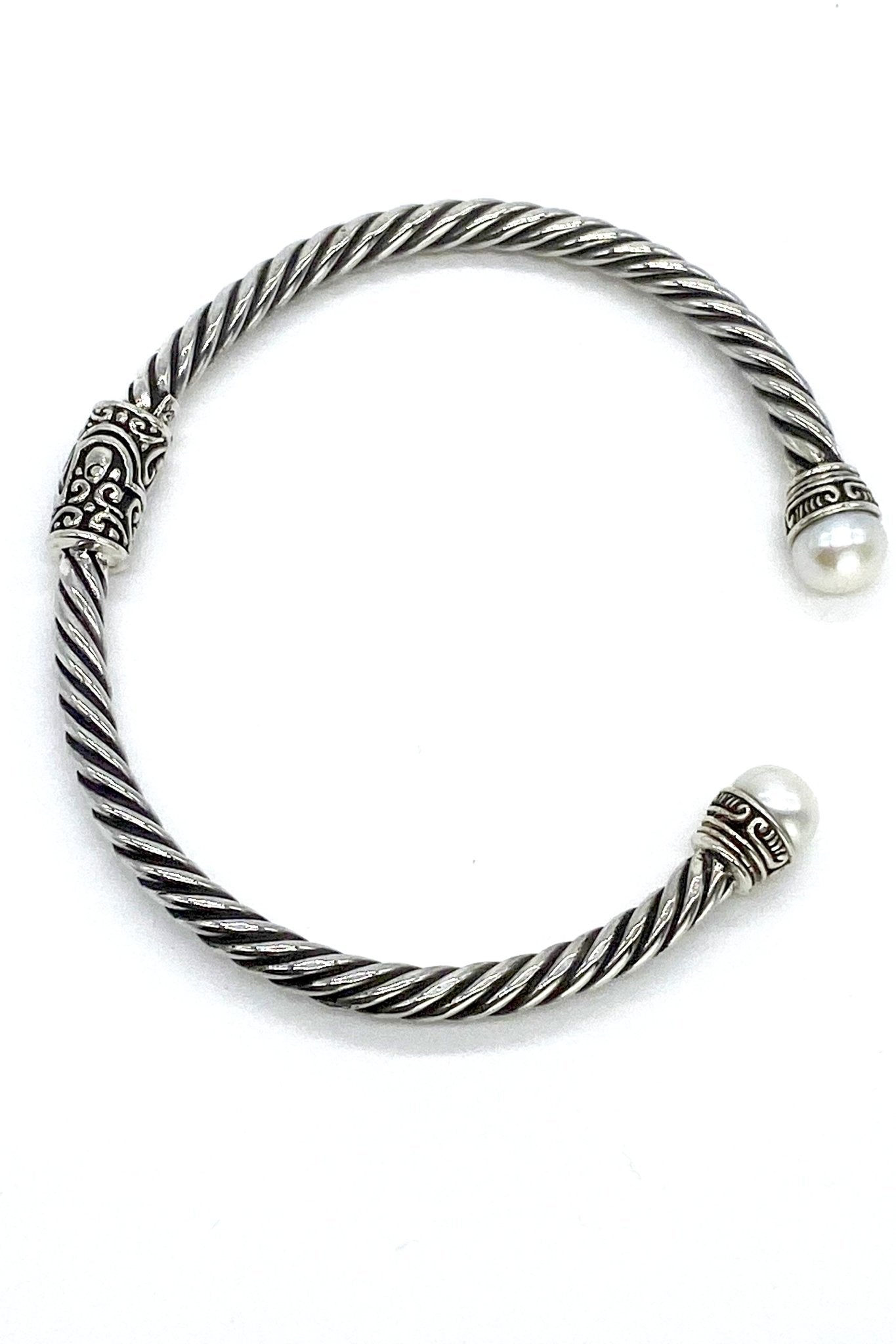 Balinese Pearl Hinged Bracelet with pearls on each end on a white background.