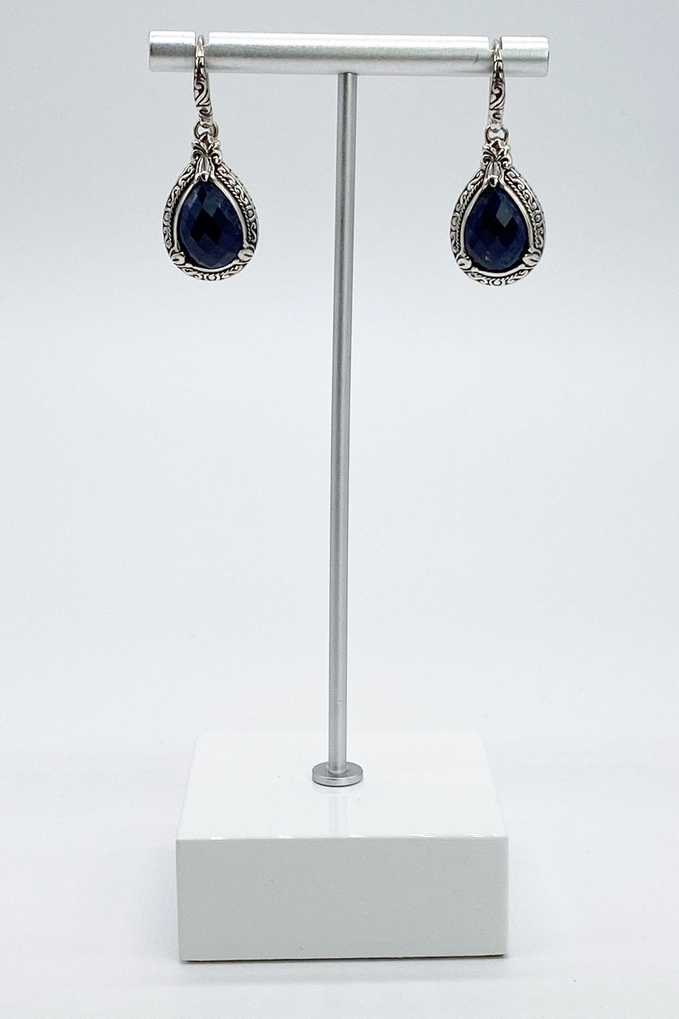 Balinese Sterling Silver Earrings in Sapphire on a whiteand silver jewelry stand
