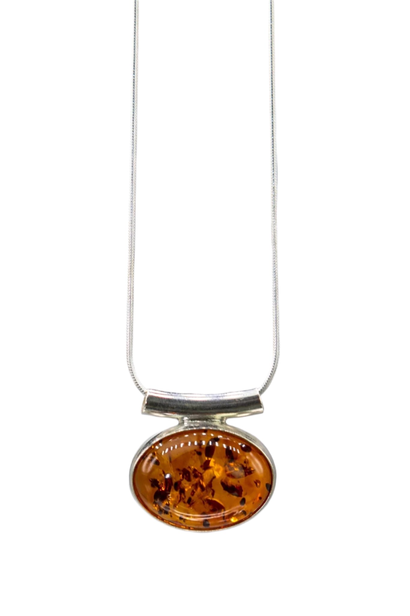 Baltic Honey Amber Slide Pendant Necklace hanging in front of a light gray background.