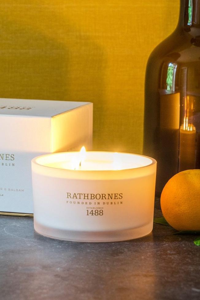 Bitter Orange, Birch Tar and Balsam Luxury Beeswax Candle displayed in a living room on a wooden table - L'Atelier Global