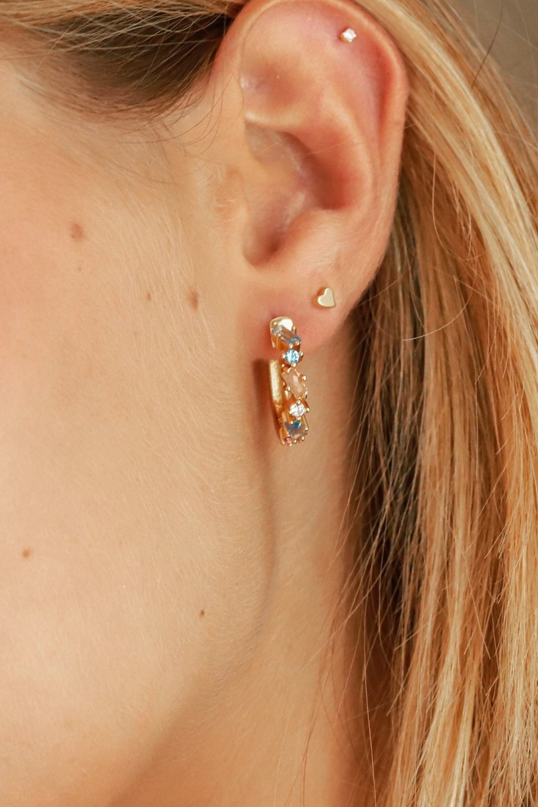 Close up image of the Burgundi Textural Hoop Earring on a female model's left ear- L'Atelier Global