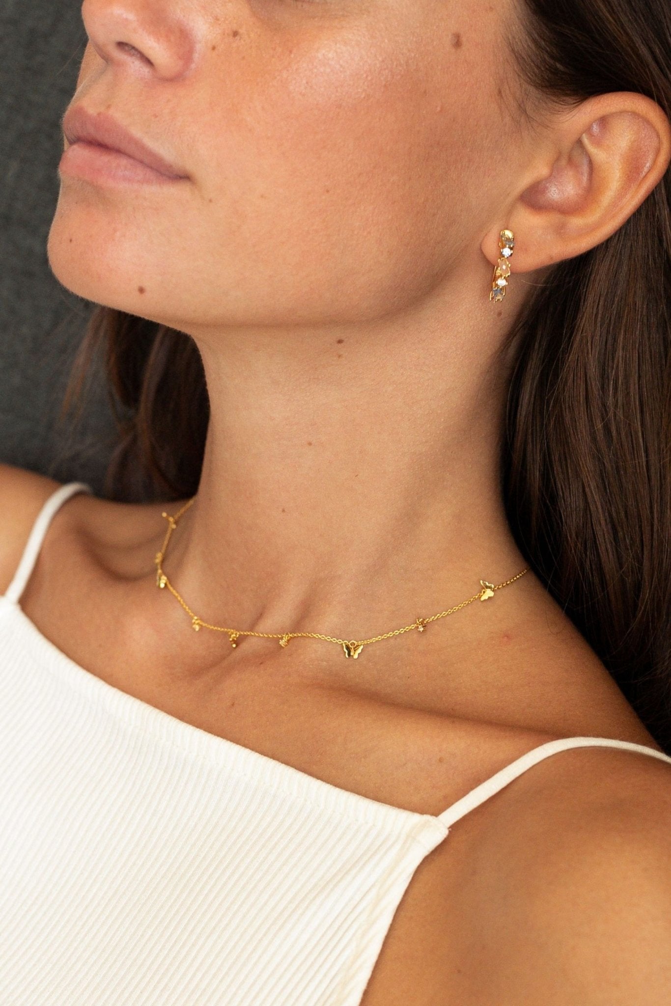 Image of the Burgundi Textural Hoop Earring on a female model's left ear- L'Atelier Global