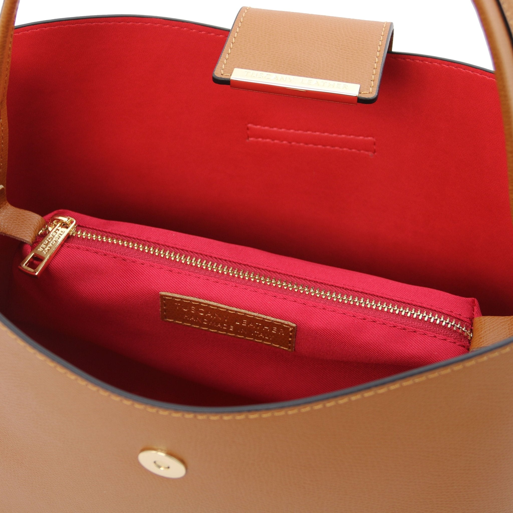 Interior central zippered compartment and vred lining view of the Clio Italian Pebbled Leather Secchiello Bag in cognac