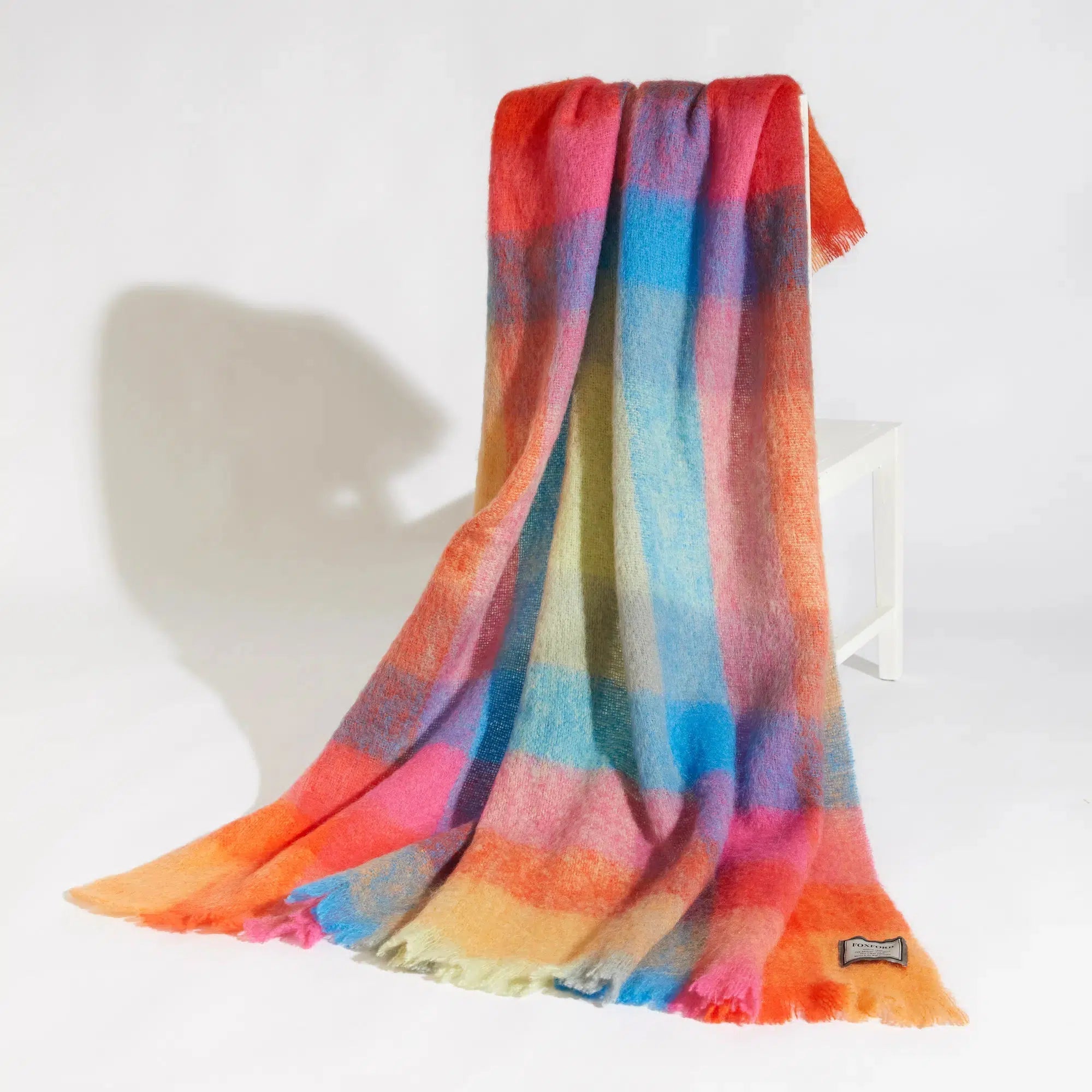 Color Block Luxuriously Soft Irish Mohair Throw laying over a chair back on a white background