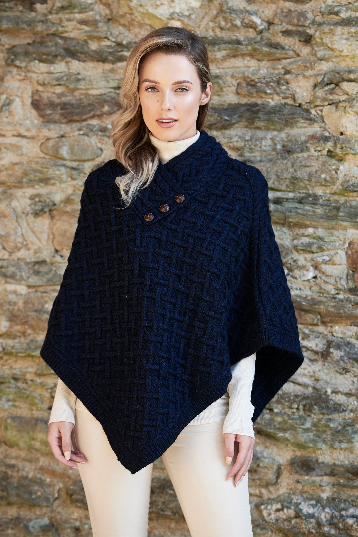 Irish Connemara Supersoft Merino Wool Poncho in dark plum on a model. Three fixed buttons are showcased on the chest