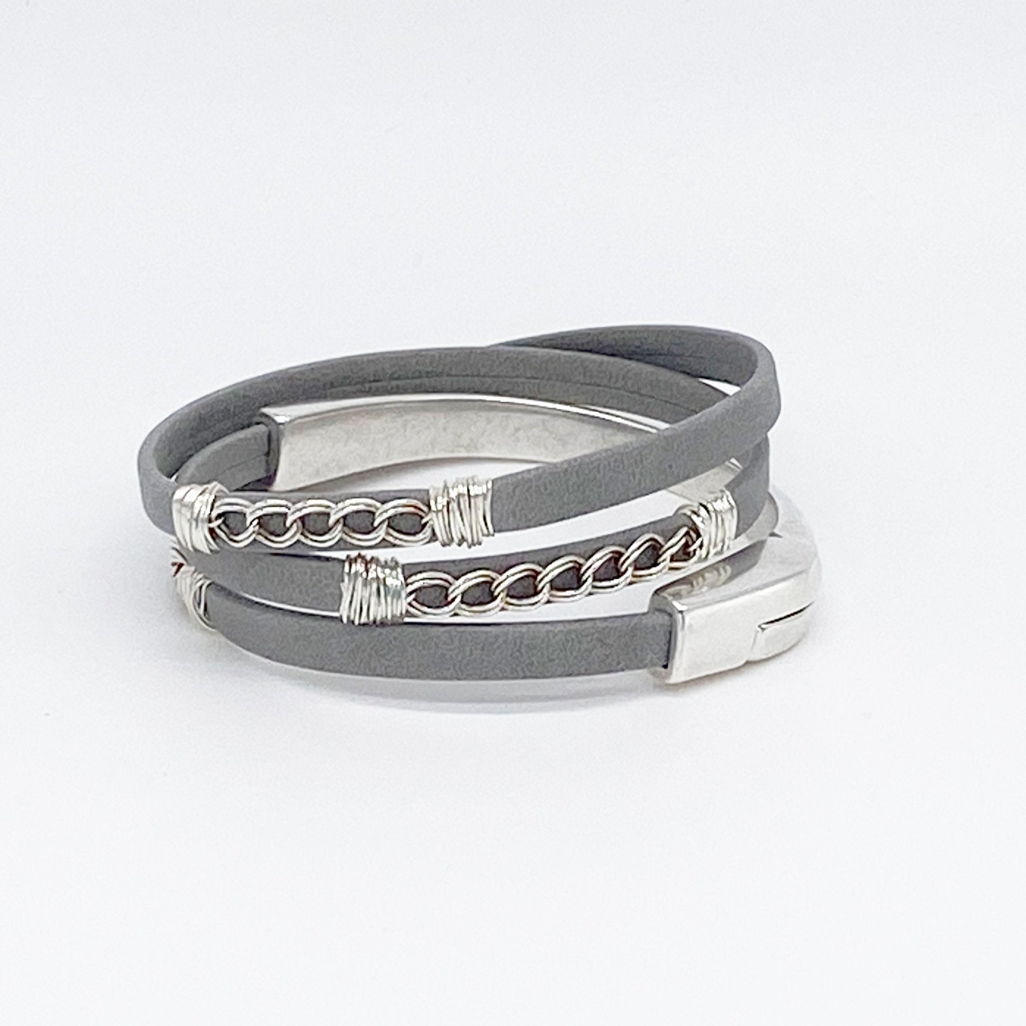 Curb Leather Triple Wrap Magnetic Bracelets in Silver laying on a white background