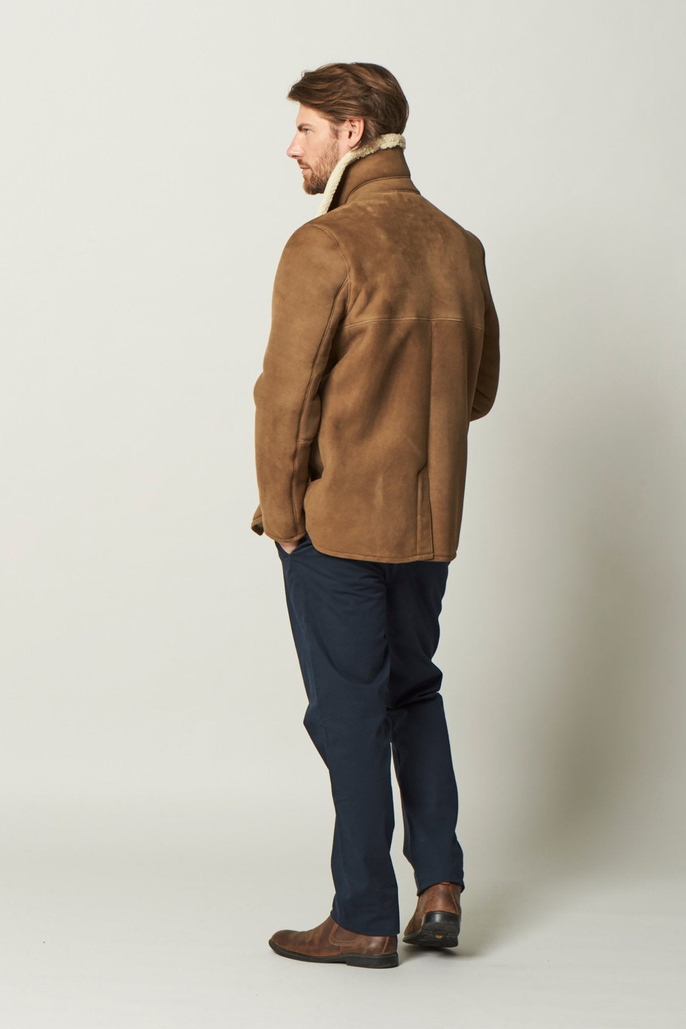 Dorset Sheepskin Jacket in Brandy back side on a male model wearing black pants - L'Atelier Global