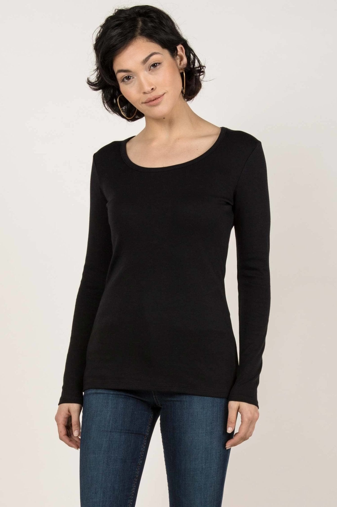 Essential Pima Cotton Layering Tee in black on female model wearing jeans. The shirt length comfortably covers her hips