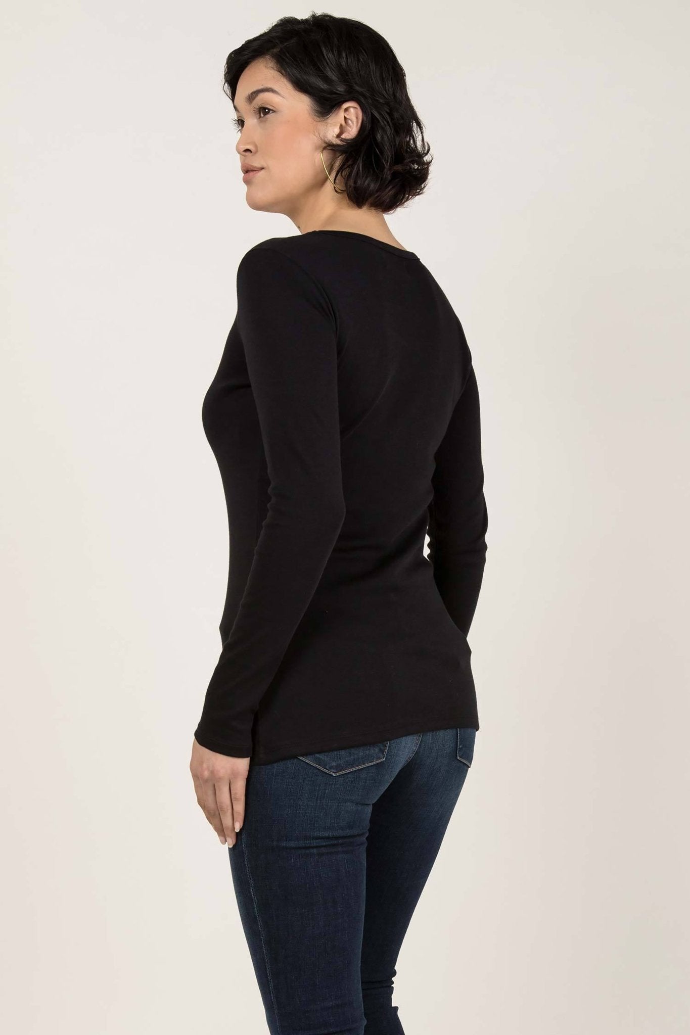 Essential Pima Cotton Layering Tee in black on female model wearing jeans. The shirt length comfortably covers her hips