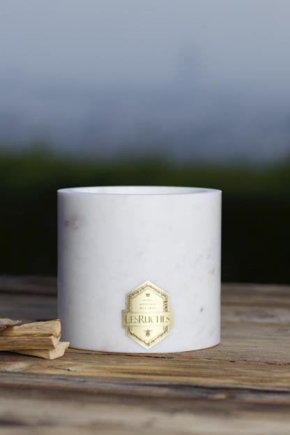 Gardenia Beauté Marbré Beeswax Candle 32 oz on wooden table with grass and sky in background