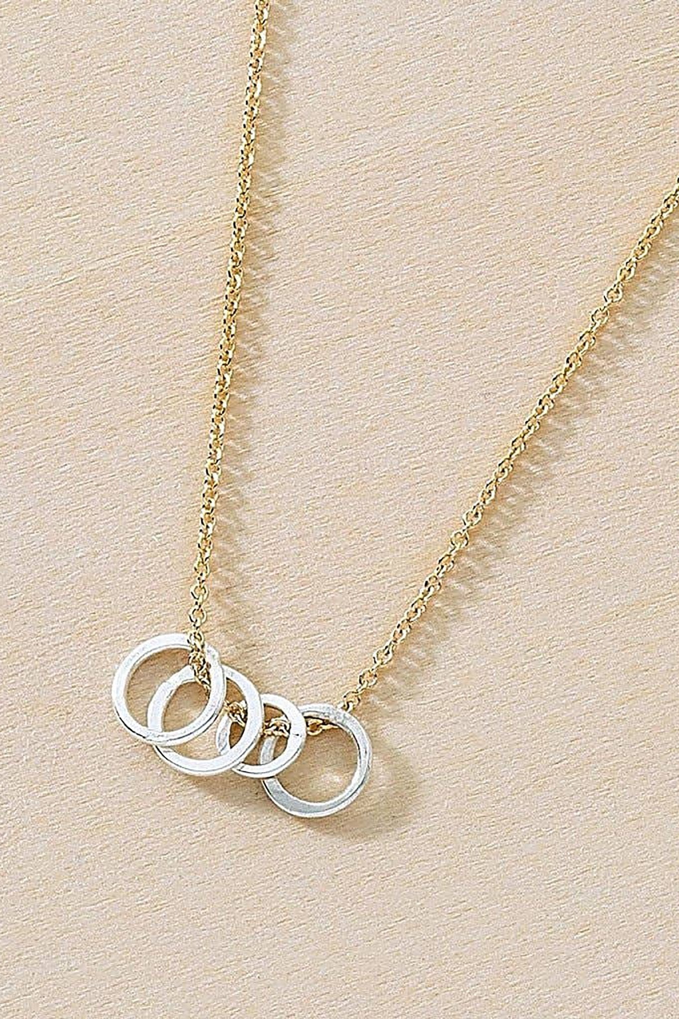 Gold Circle Cluster Necklace on a tan background - L'Atelier Global