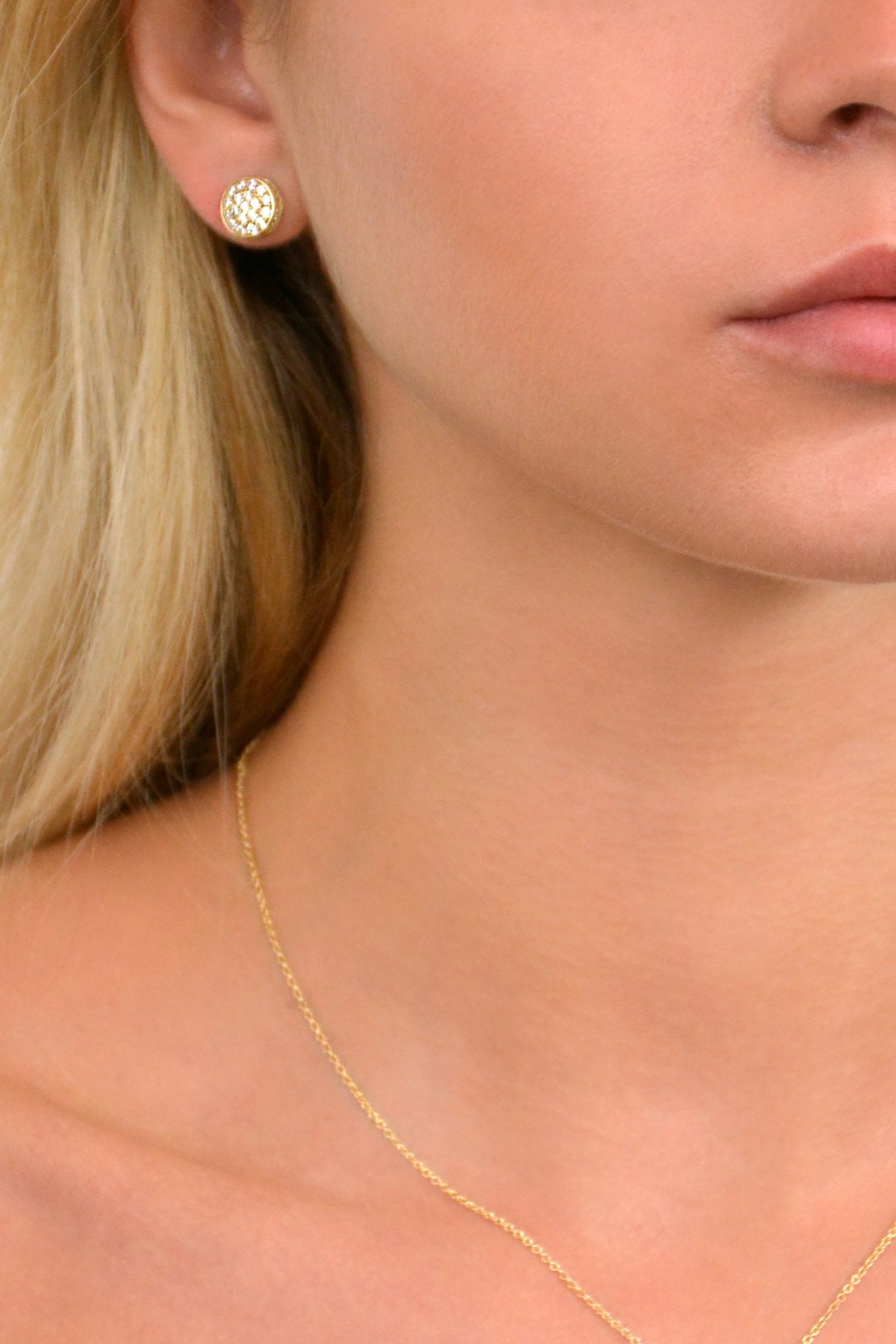 Gold Dazzle Earrings on a model presented on her right ear - L'Atelier Global