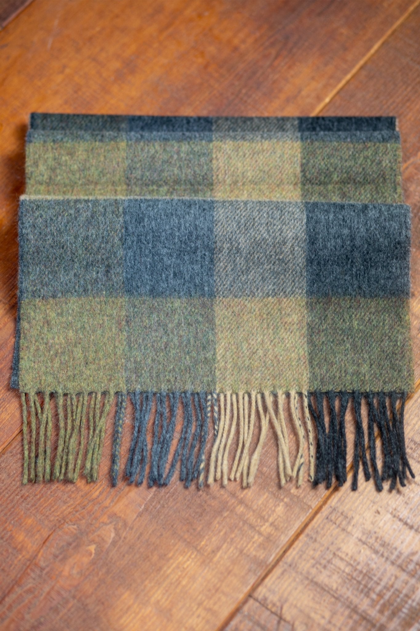 Golden Vale Luxe Lambswool Scarf folded on a wood background