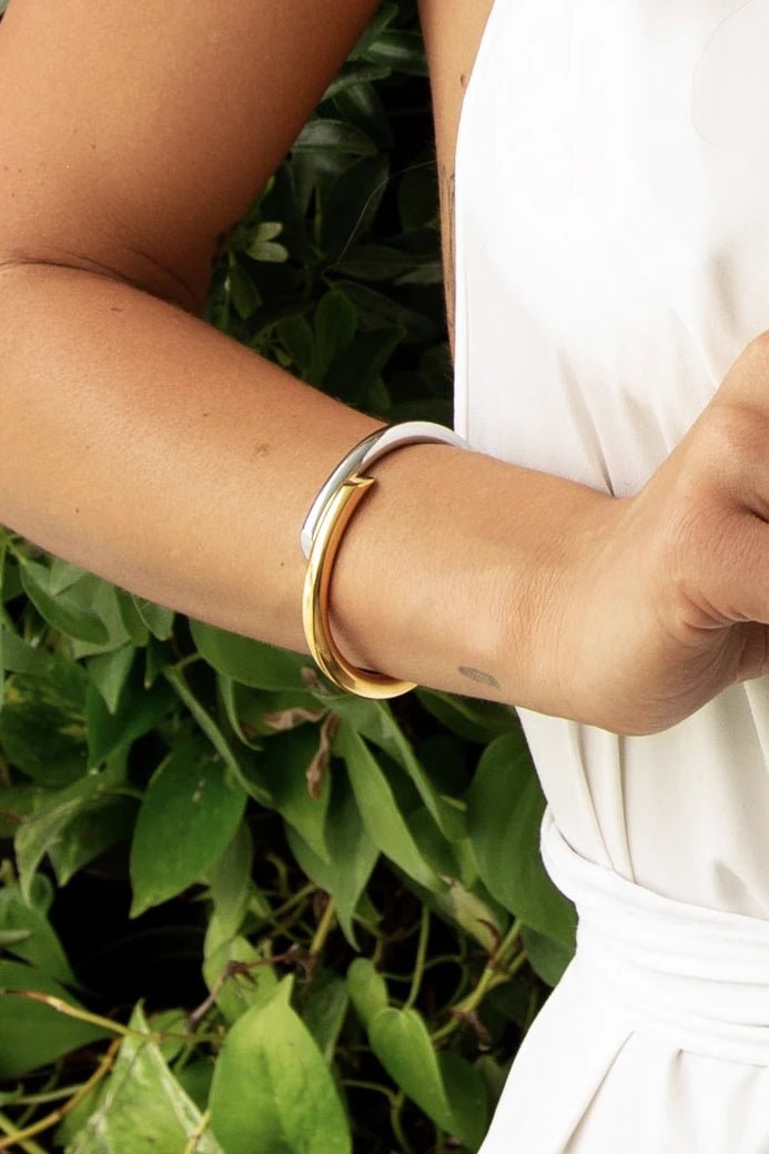 Close view of the Helena Brazilian Two - Tone 18K Gold Cuff on a woman's wrist