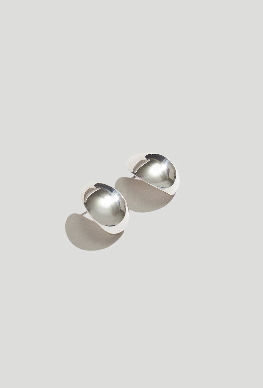 Huggie Earrings Sterling Silver on a light gray background