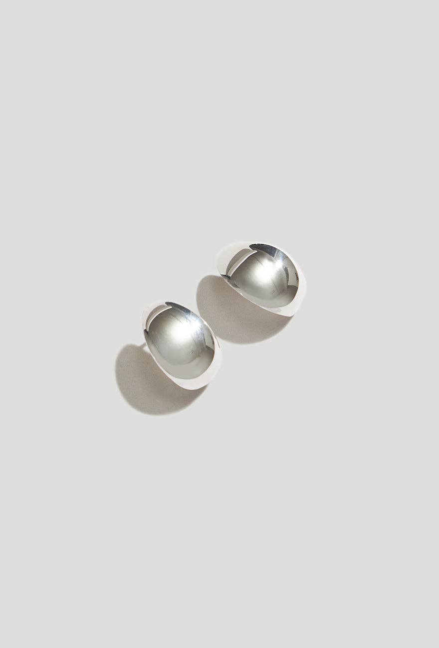 Huggie Earrings Sterling Silver on a light gray background