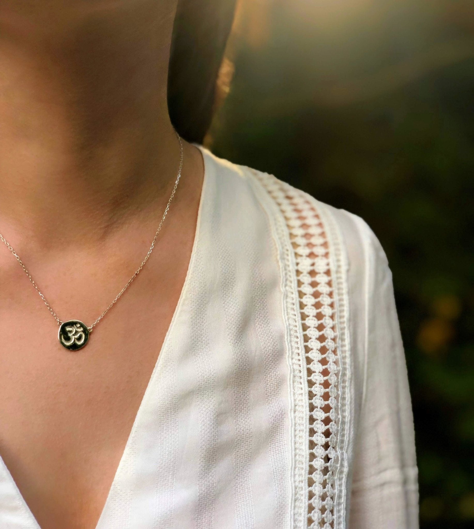 Inner Peace Silver Necklace on a model wearing a white blouse - L'Atelier Global