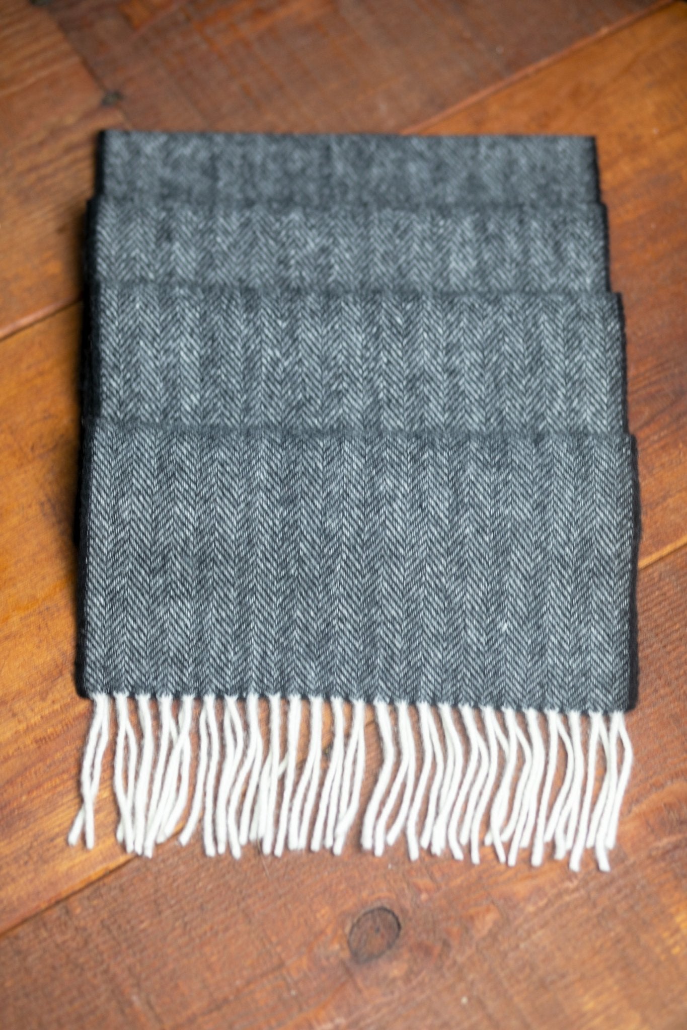 Irish Classic Herringbone Lambswool Scarf folded on a wood background - L'Atelier Global