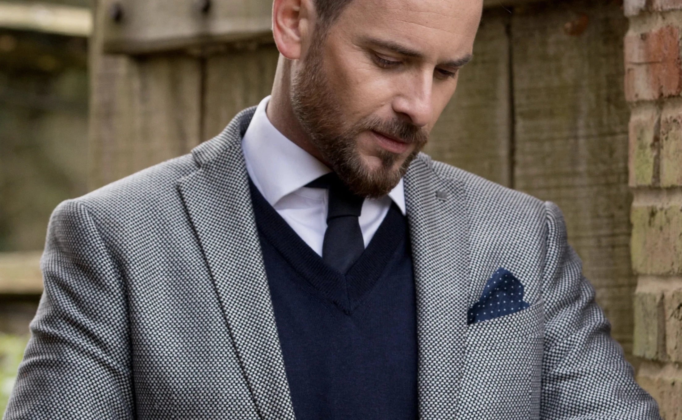 Man in a suit wearing the Italian Extra Fine Merino Wool V-Neck in navy