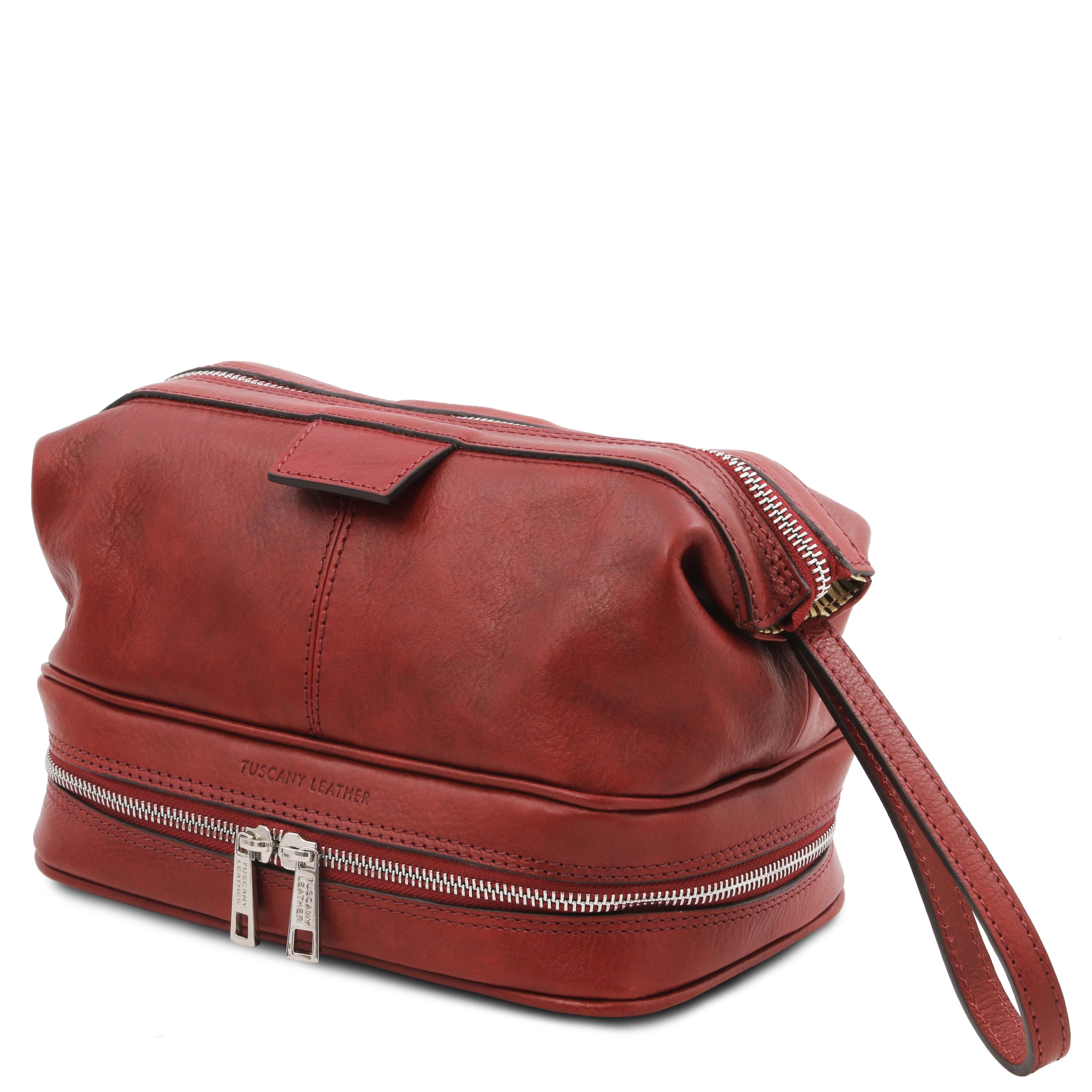 Side view showing handle, Jacob Leather Toilet Bag in red on a white backgroundl