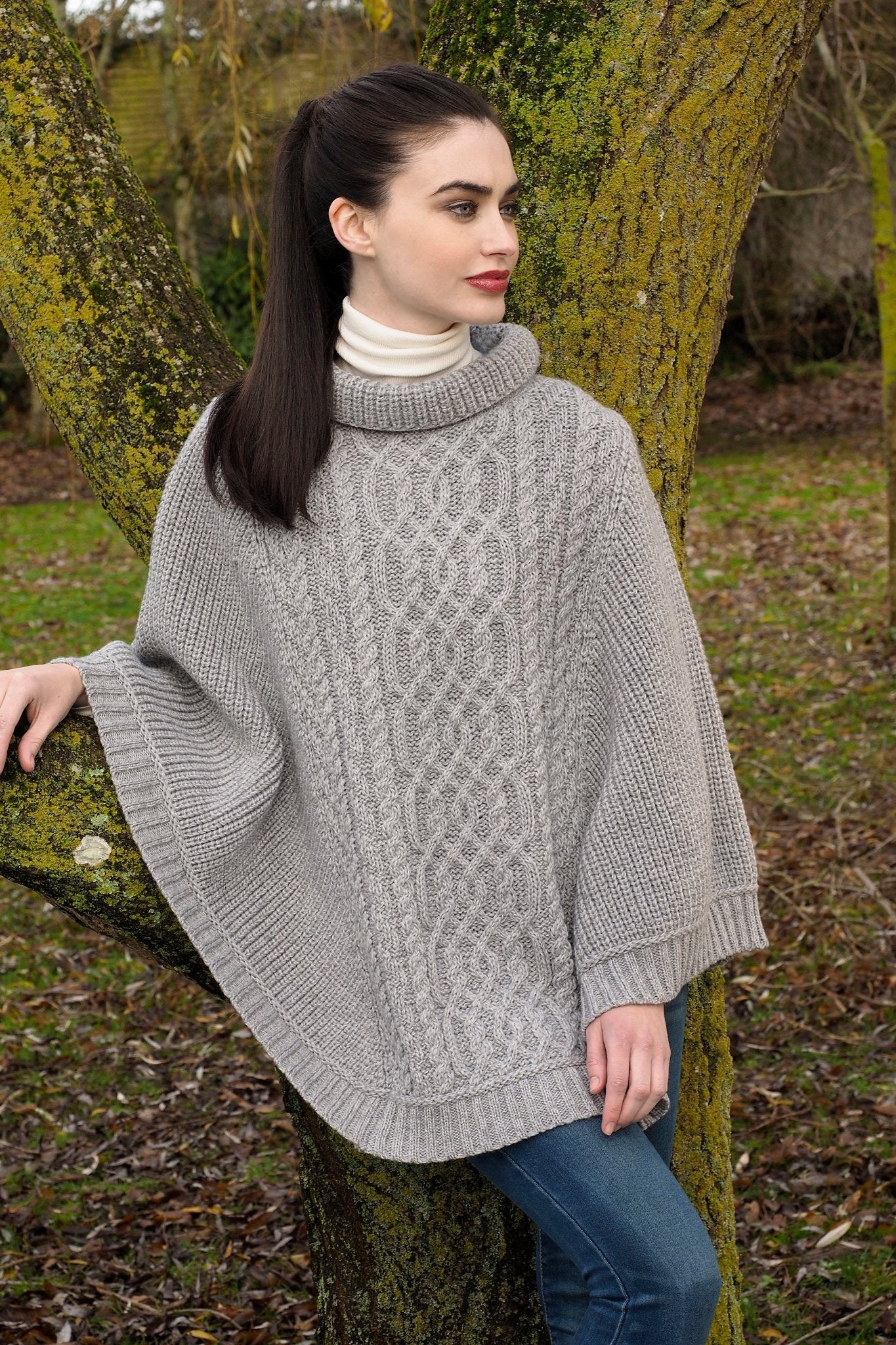 Kildare Effortless Supersoft Relaxed Turtleneck Poncho in soft gray on model wearing jeans with a long dark brown pony tail - L'Atelier Global