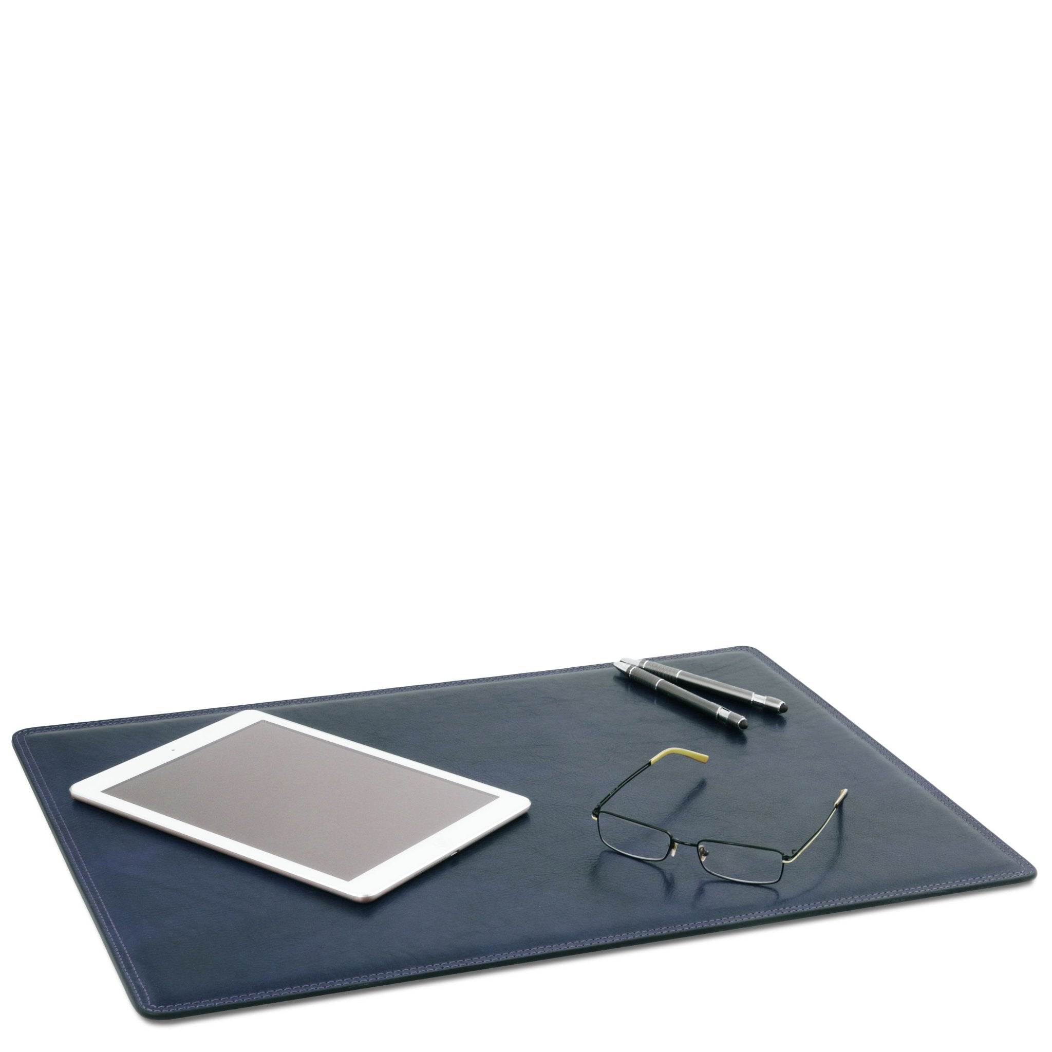Leather Desk Pad in Dark Blue laying down on a white background with a phone, pens and glasses set on top