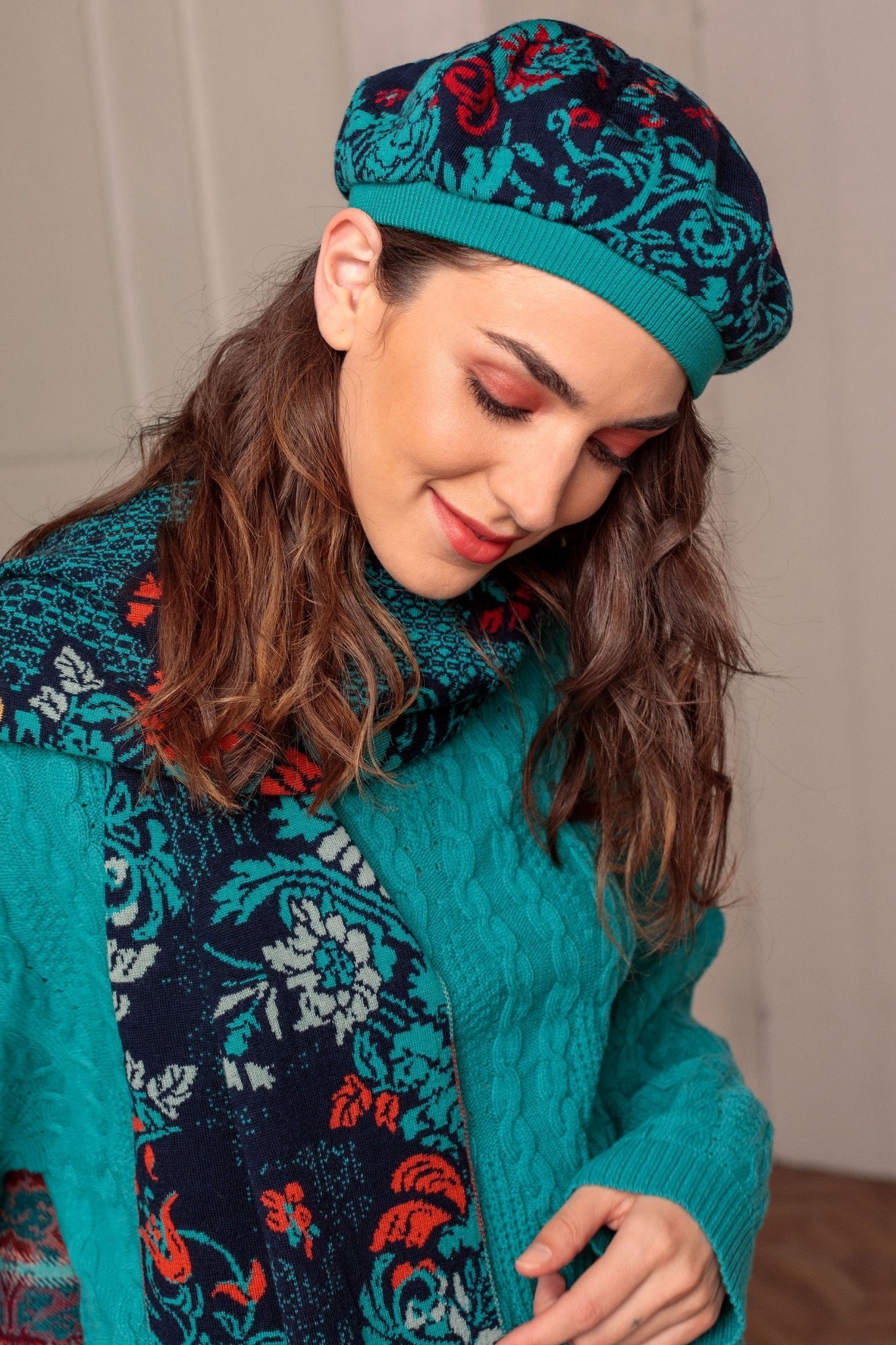 A woman is wearing the Lily of The Valley Serbian Merino Wool Hat and scarf in blue