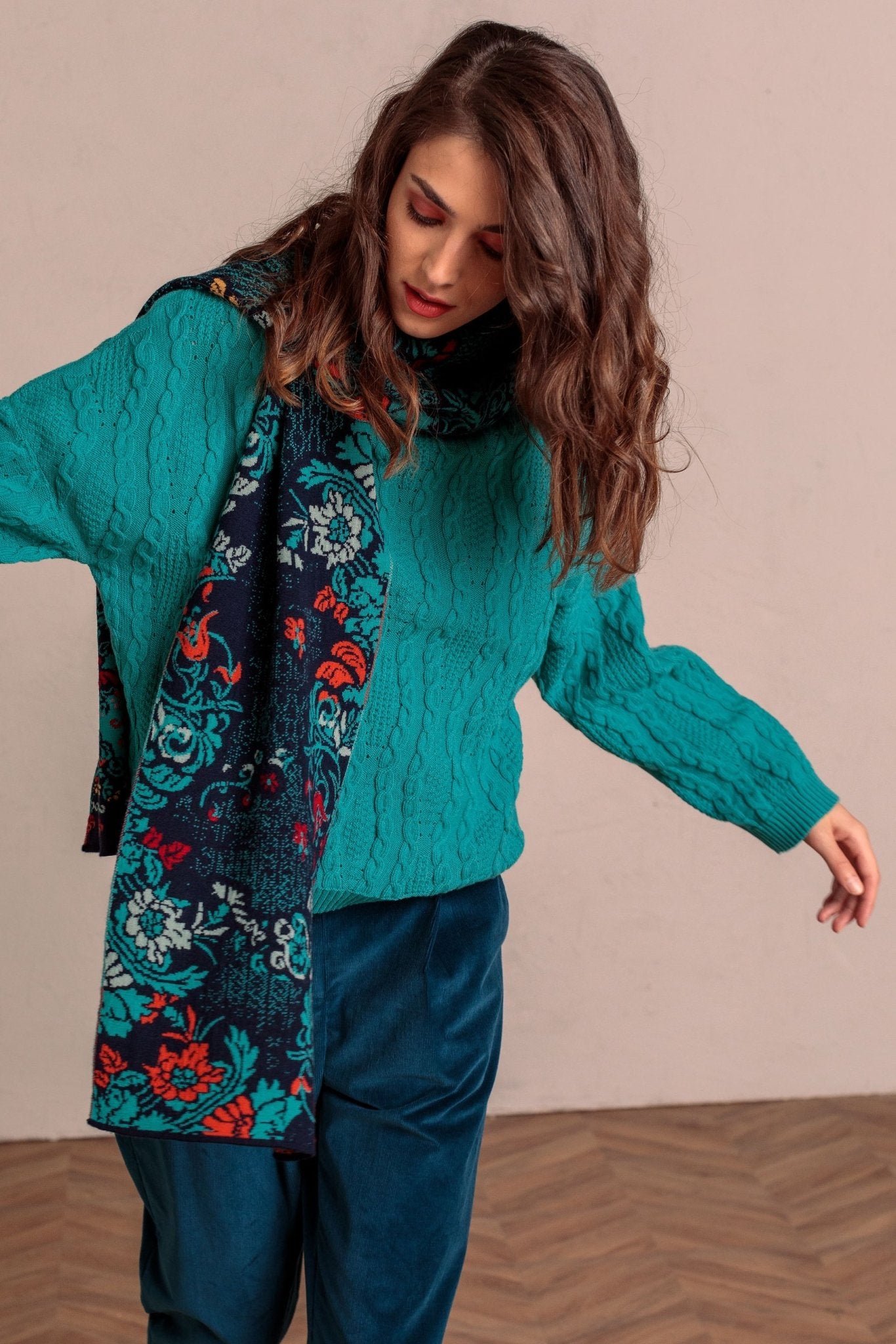 Lily of The Valley Serbian Merino Wool Scarf on a model wearing a bright blue sweater and black pants