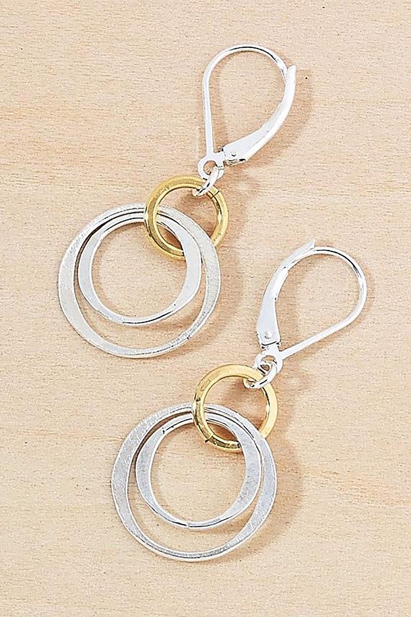 Linked Circle Drop Gold and Silver Earrings on a tan background - L'Atelier Global