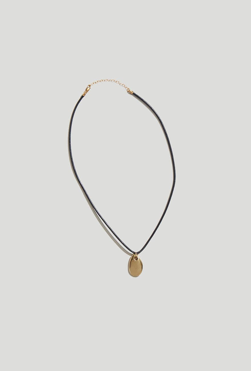 Louisa Gold Pebble Pendant Cork Necklace on a light gray background showing the gold extender chain