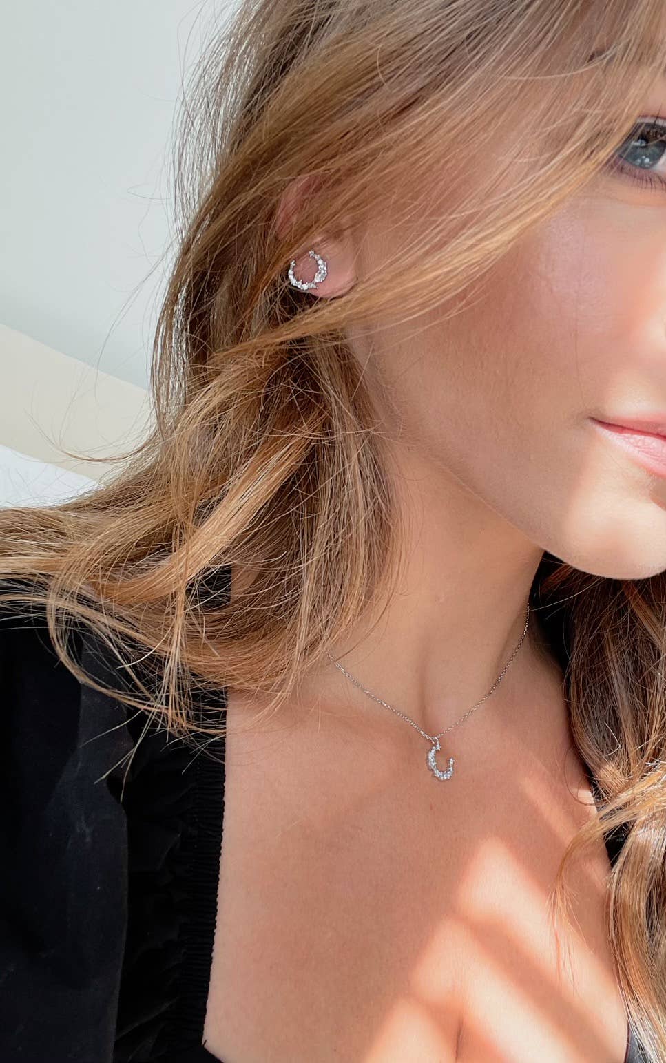 Luna Pavé Stud Earrings on a female model wearing a black dress - L'Atelier Global