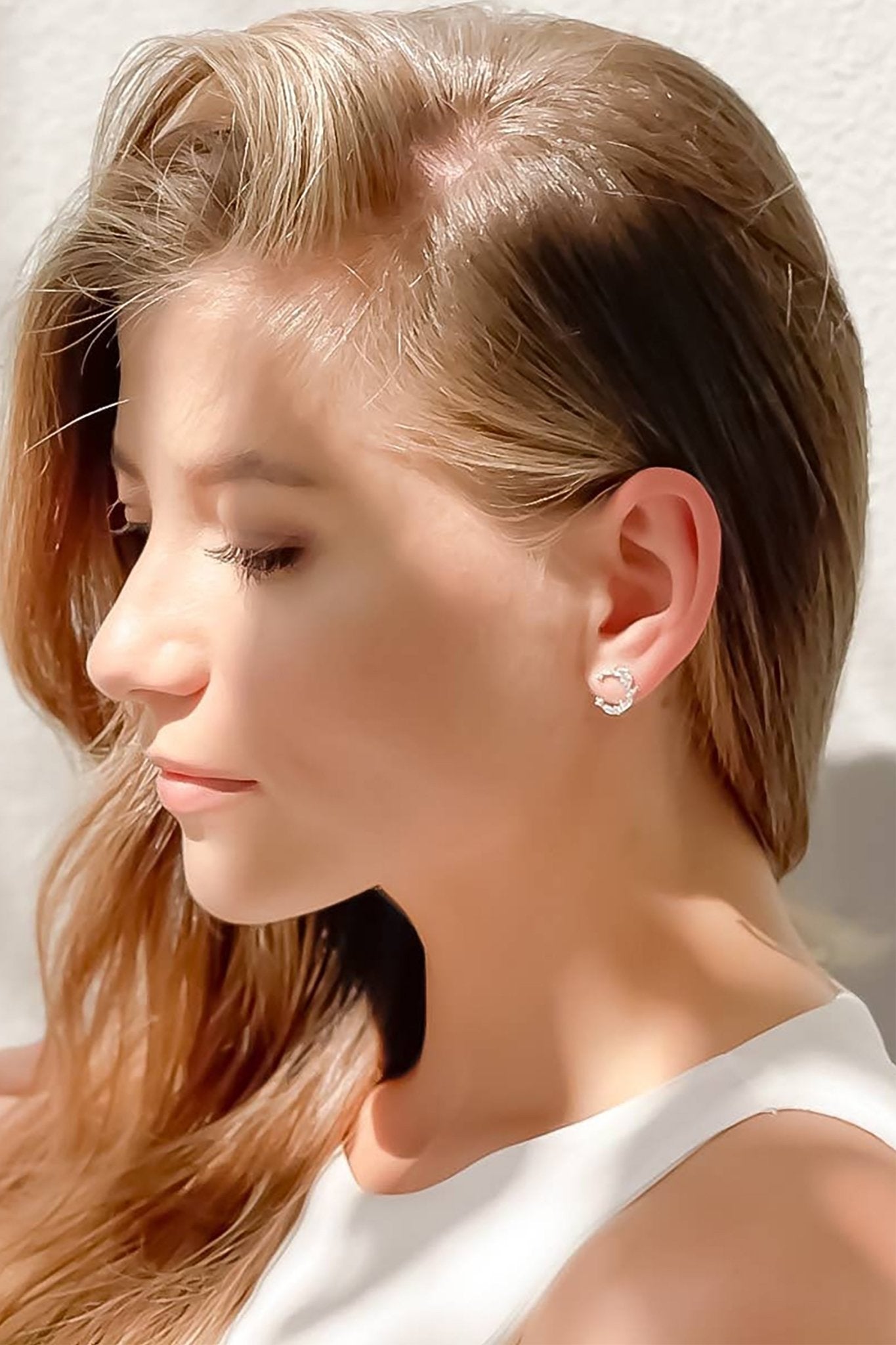 Luna Pavé Stud Earrings on a female model wearing a white dress - L'Atelier Global