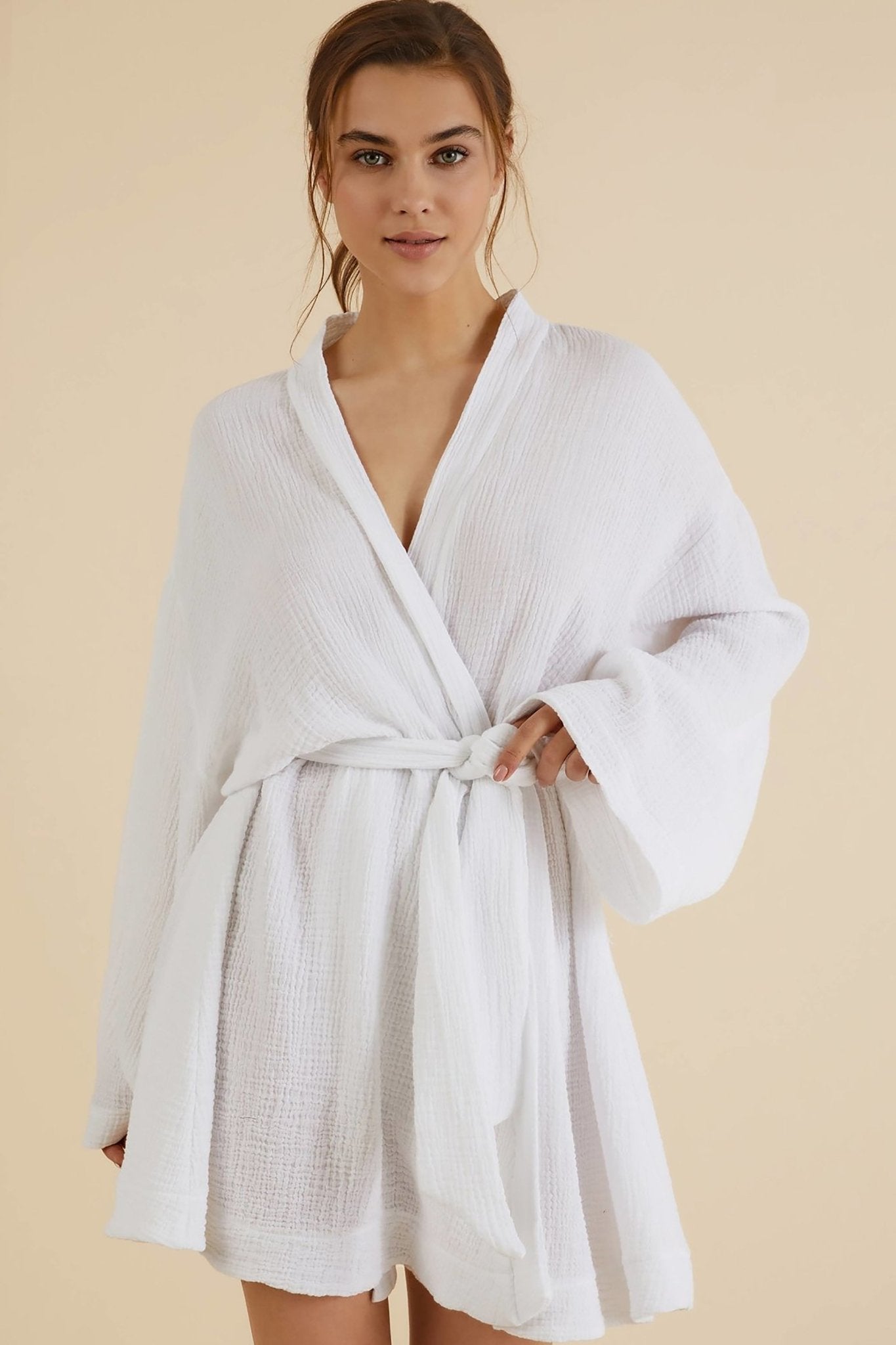 Luxe Luna Kimono Wrap is tightly belted off center on a model in front of a natural-hued background.