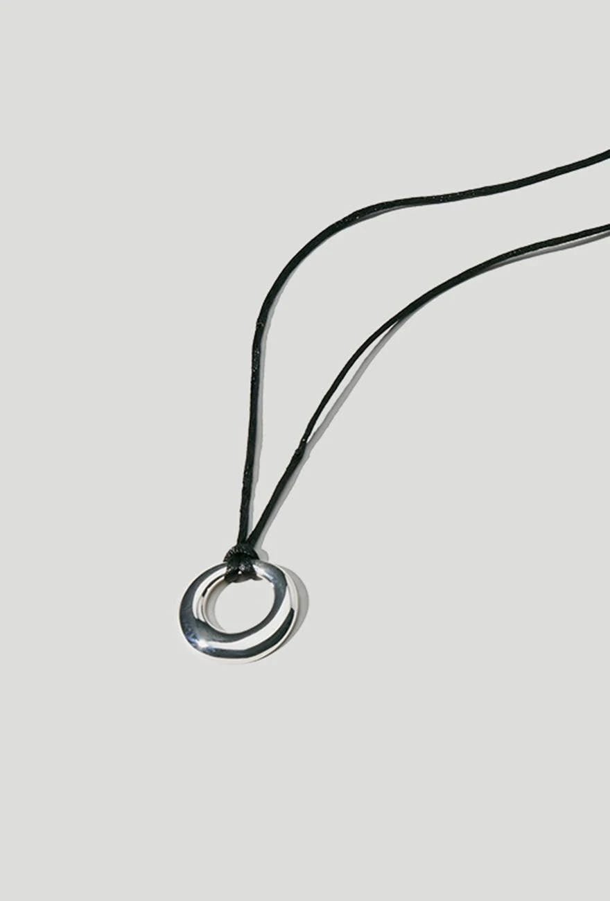 Magnus Minimalistic Circle Necklace on a light gray background - L'Atelier Global