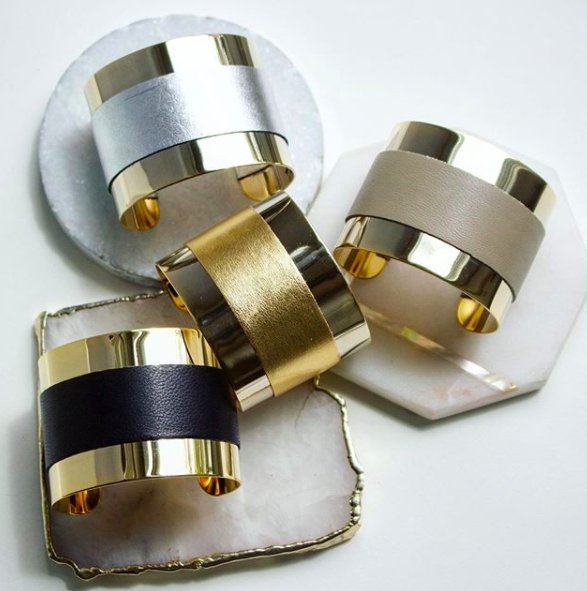 Manhattan Leather Detail Wrap Cuffs laying on coasters on a white background