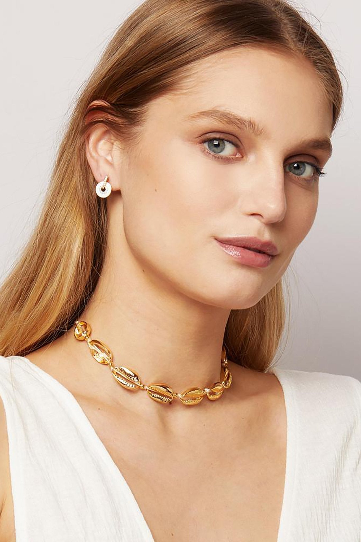 Medallion Gold Enamel Stud Earrings on a female model wearing a v-neck blouse
