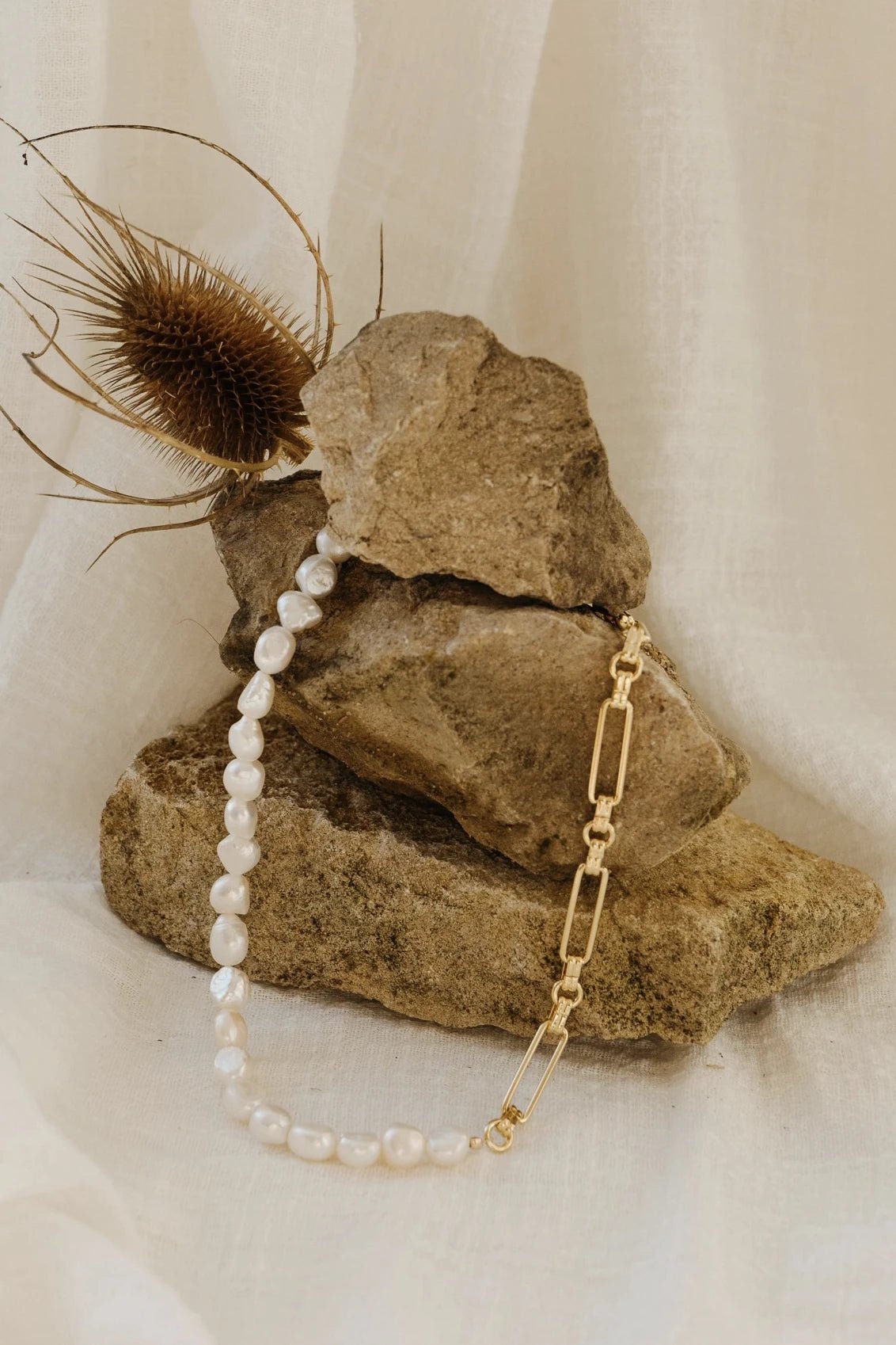 Menton Freshwater Pearl and Gold Choker on a rock presenting the blend with nature - L'Atelier Global
