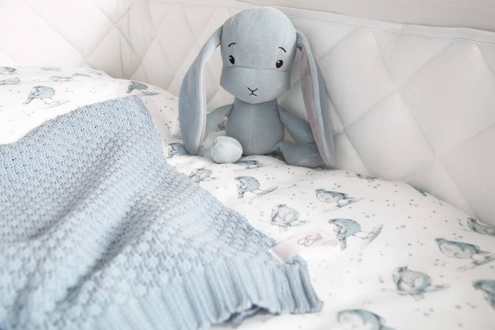 Natural Cotton Baby Blanket in Blue on a child's bed - L'Atelier Global