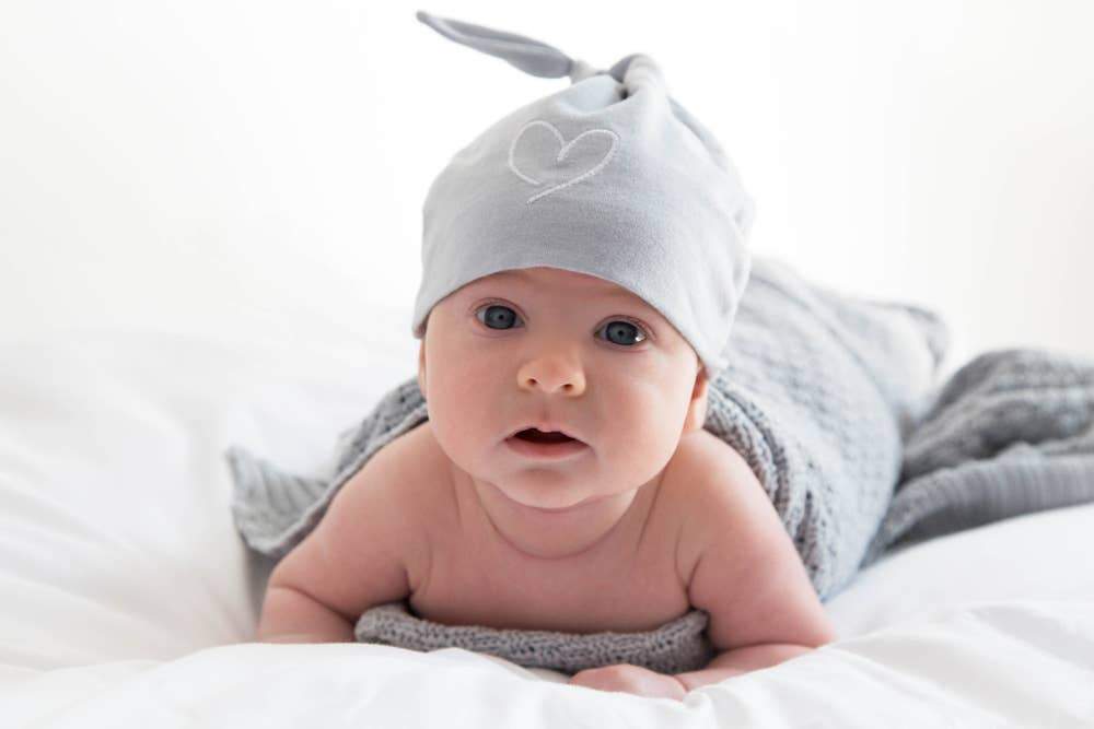 Natural Cotton Baby Blanket in Gray wrapped around a baby boy - L'Atelier Global