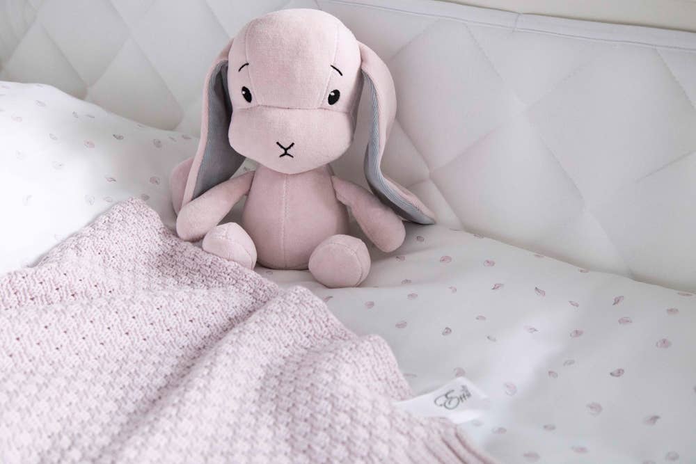 Natural Cotton Baby Blanket in Pink on a child's bed with the pink Effik small bunny - L'Atelier Global