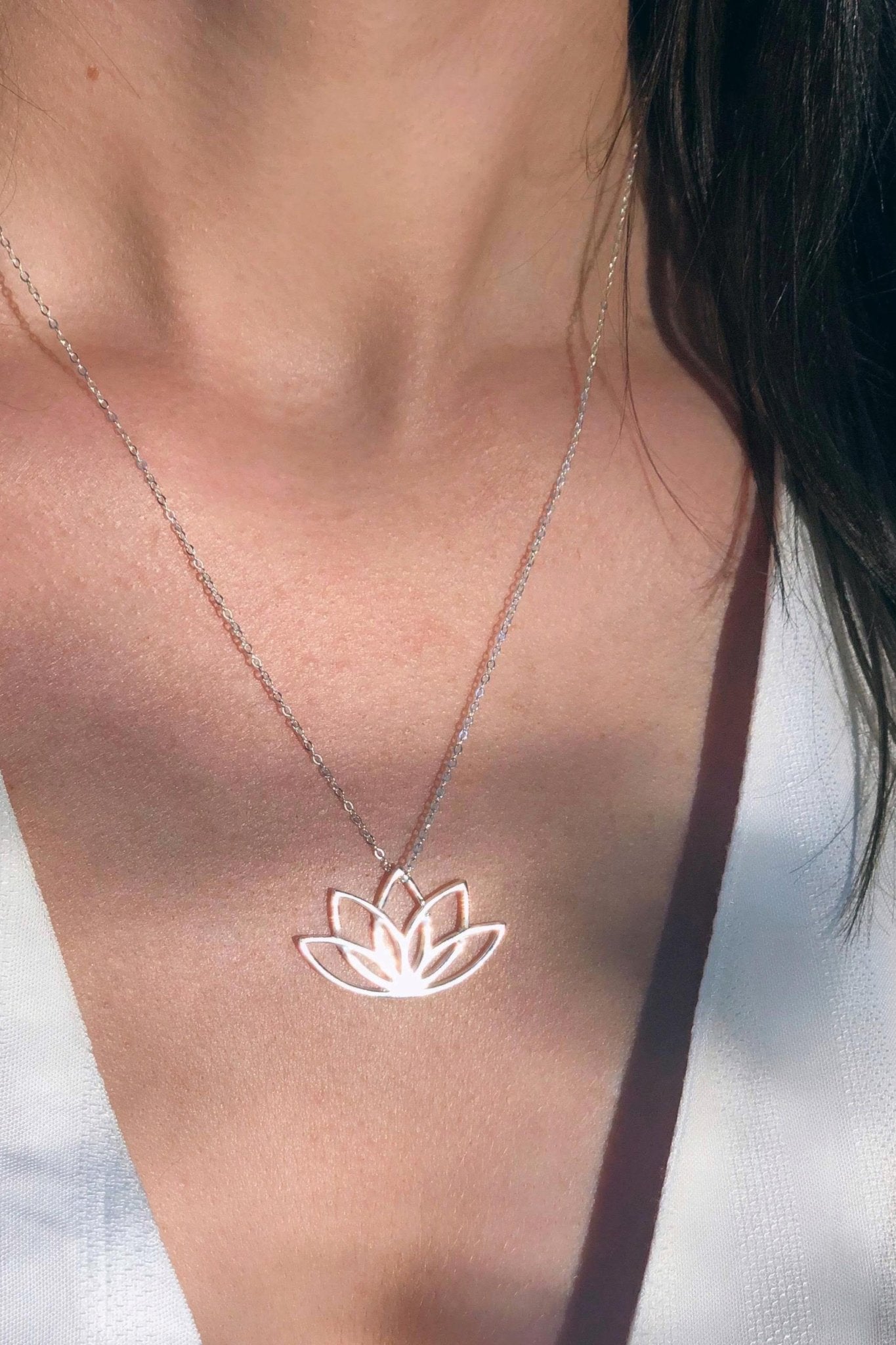 Irish New Beginnings Silver Necklace on a model wearing a white cotton v-neck blouse - L'Atelier Global