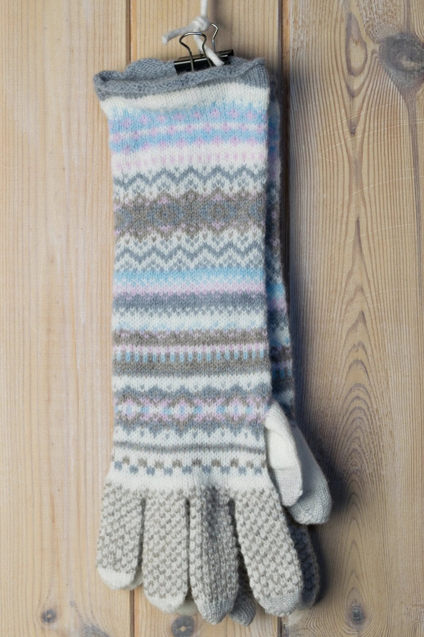 Northern Isles Merino Wool Gloves in Mist hanging on a wood background - L'Atelier Global
