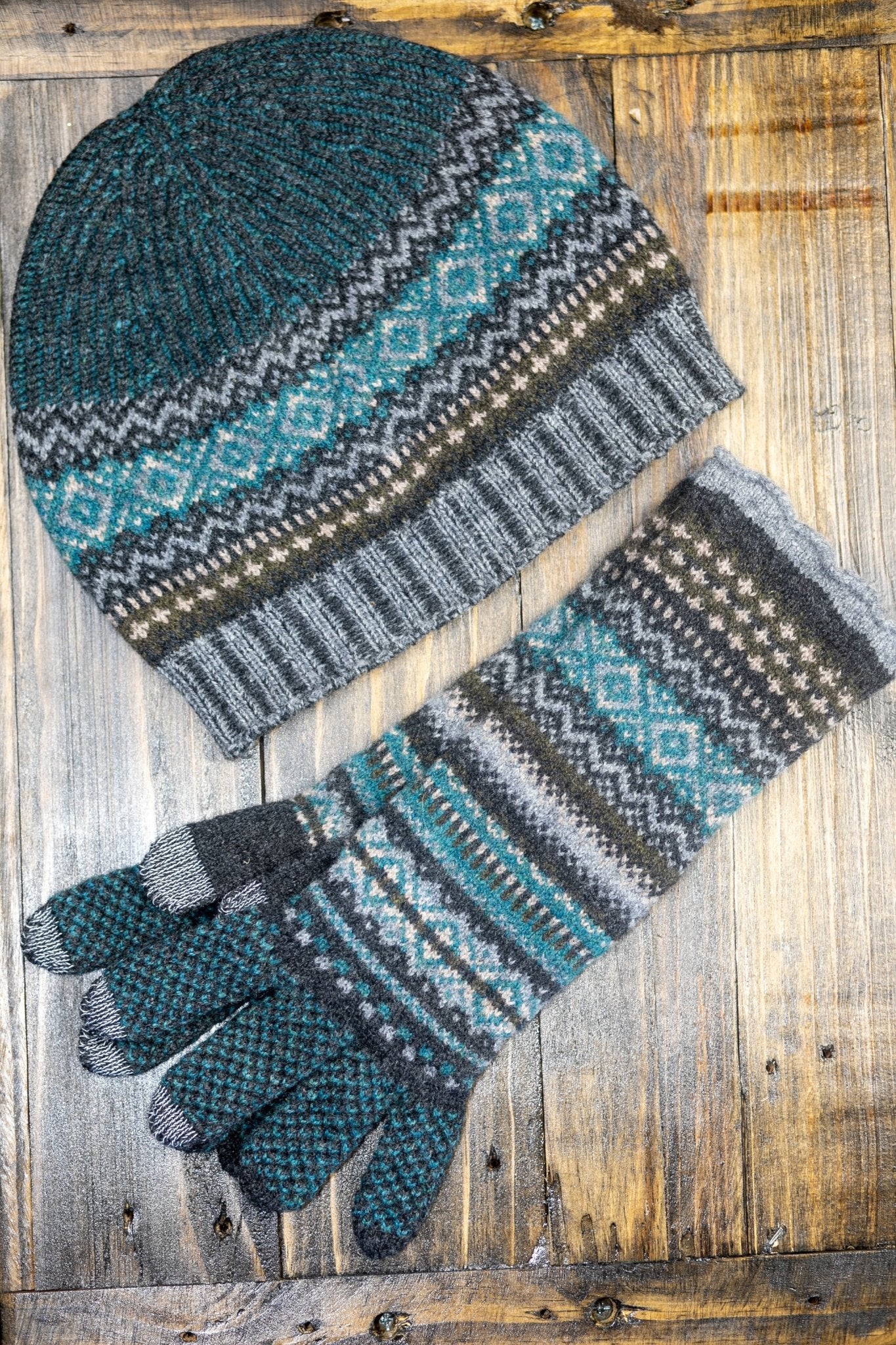 Northern Isles Merino Wool Beanie and Gloves in Gray on a wood background - L'Atelier Global